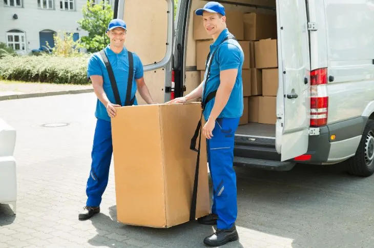 Group of movers unloading a moving truck.